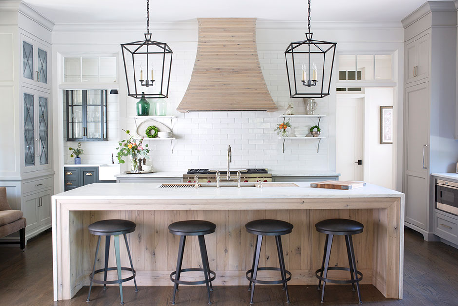 10' kitchen island with single large sink in the middle, directly across from a symmetrical cooktop in the wall cabinetry.
